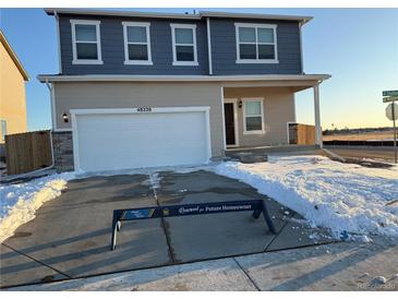 Charming two-story home with a two-car garage and well-maintained landscaping at 48220 Shetland Dr, Bennett, CO 80102