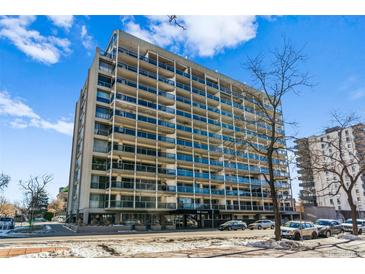 Large condo building with multiple balconies, situated in an urban setting under a bright sky at 888 N Logan St # 5A, Denver, CO 80203