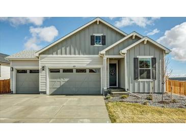 Charming exterior showcasing a two-car garage, well-maintained lawn, and inviting entryway for a welcoming curb appeal at 1171 Nathan Pl, Erie, CO 80026