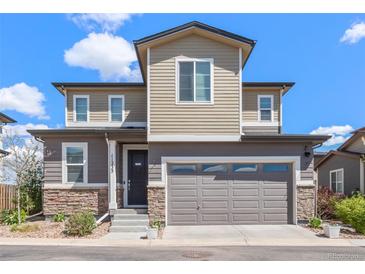 Charming two-story home with neutral siding, stone accents, and a two-car garage on a sunny day at 11235 S Neu Towne Cir, Parker, CO 80134