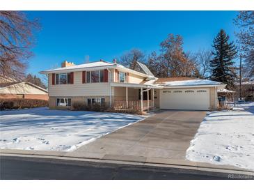 Ranch style home with attached garage and snow-covered yard at 900 Emerald St, Broomfield, CO 80020