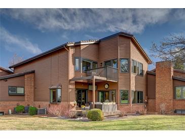 A beautiful home exterior with a balcony, patio, and manicured backyard perfect for entertaining at 5745 W Mansfield Ave # 265, Denver, CO 80235