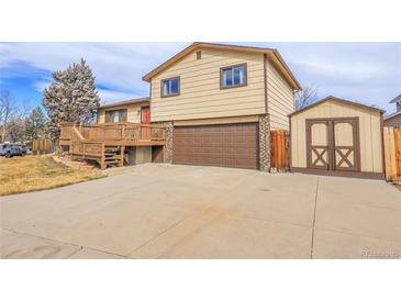 House exterior features a two-car garage and a deck at 9359 W Lake Dr, Littleton, CO 80123