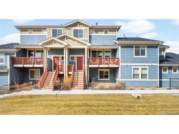 Charming townhomes with private balconies and manicured front lawns create a welcoming curb appeal at 883 Widgeon Cir, Longmont, CO 80503