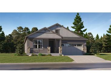 Charming single-story home featuring a mix of lap siding and shake in a gray palette with stone pillar accents at 737 Raindance St, Erie, CO 80516