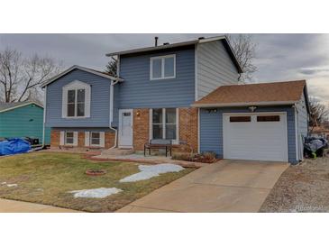 Two-story house with attached garage and landscaped yard at 614 Glenwood Dr, Lafayette, CO 80026