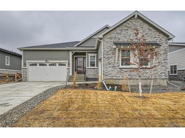 Charming single-Gathering home featuring stone accents, a two-car garage, and a well-manicured front yard at 3630 Gold Bug St, Aurora, CO 80019