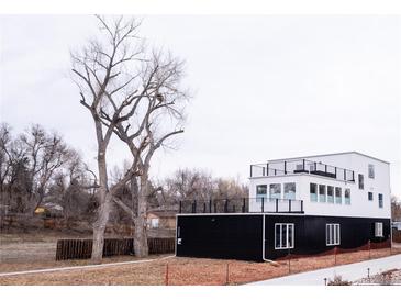 Contemporary two-story home boasting sleek black and white exterior, and multiple balconies for outdoor enjoyment at 5462 S Cedar St, Littleton, CO 80120