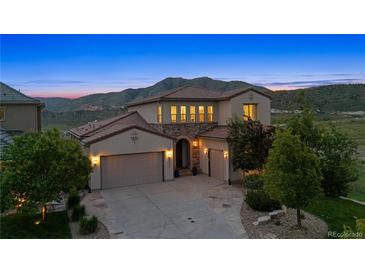 Stunning home with a three-car garage and picturesque mountain views in the background at 15490 W Asbury Ave, Lakewood, CO 80228