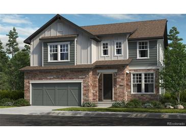 Two-story home featuring a stone and gray siding exterior, attached garage, and well-manicured lawn at 15456 Krameria St, Thornton, CO 80602