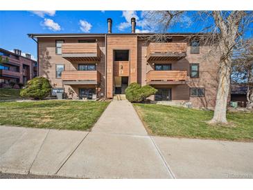 Condominium building featuring multiple units with balconies and well-maintained landscaping at 205 Wright St # 104, Lakewood, CO 80228