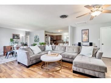 Spacious living room featuring a large sectional sofa and hardwood floors at 1800 S Tennyson St, Denver, CO 80219