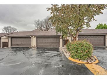 Attached garages with brown doors offer convenient parking and storage in this townhome community at 12010 E Harvard Ave, Aurora, CO 80014