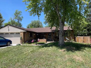 Charming single-story home with a well-manicured lawn and a cozy front porch at 9115 W 2Nd Ave, Lakewood, CO 80226