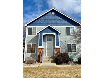 Charming two-story townhome with inviting front porch and well-maintained landscaping at 12941 Lafayette St # E, Thornton, CO 80241