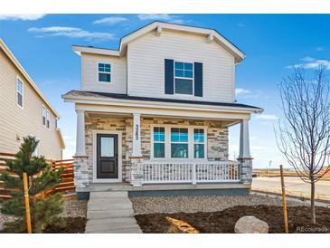 Charming two-story home featuring stone accents, a cozy porch, and a well-maintained front yard at 3282 N Catawba Way, Aurora, CO 80019