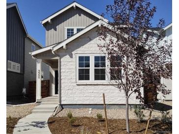 Two-story home with white brick exterior and gray accents at 3355 N Coolidge Way, Aurora, CO 80019