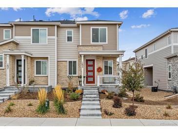 Charming two-story home with a red front door, landscaped yard, and inviting entryway at 1635 S Andes Way, Aurora, CO 80017