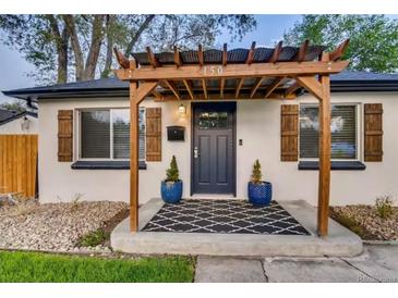 Charming home featuring a pergola over the entry way, stylish shutters, and a welcoming black and white patterned rug at 150 S Osceola St, Denver, CO 80219