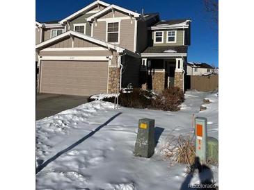 Two-story home with attached garage and snowy front yard at 6317 Wescroft Ave, Castle Rock, CO 80104