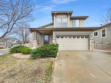 Charming two-story home featuring neutral siding, manicured landscaping, and an attached two-car garage at 10674 Cherrington St, Highlands Ranch, CO 80126