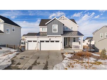 Two-story house with gray and white siding, three-car garage, and a landscaped yard at 1171 E Hopkins Dr, Elizabeth, CO 80107