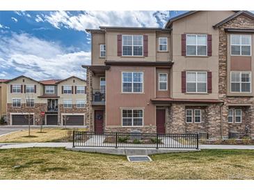 Charming multi-story home with stone accents, landscaped yard, and a welcoming entrance at 2225 Santini Trl # A, Littleton, CO 80129