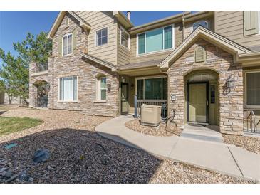 Charming townhome with stone facade, walkway, and well-maintained landscaping in a desirable community at 11277 Osage Cir # E, Westminster, CO 80234