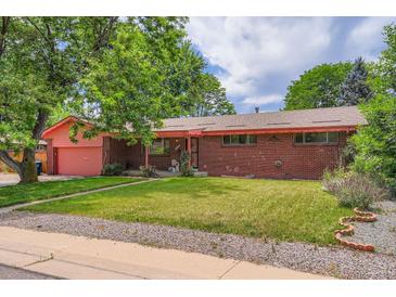 Charming brick home featuring a well-maintained lawn and a lovely covered porch at 4465 Cody St, Wheat Ridge, CO 80033