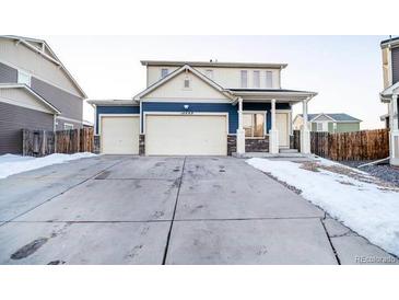 Inviting two-story home boasts a large driveway and attached two-car garage at 10669 Worchester Dr, Commerce City, CO 80022