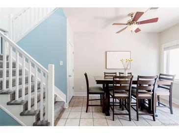 Bright dining room with a ceiling fan and staircase leading to the next level at 2800 Aurora Ave # 121, Boulder, CO 80303
