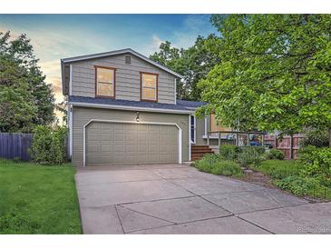 Charming two-story home with a well-maintained lawn and a large two car garage at 284 S Lincoln Ave, Louisville, CO 80027