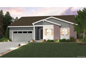 Charming single-Gathering home with brick accents, a two-car garage, and a well-manicured lawn at 1400 Colony Dr, Erie, CO 80026