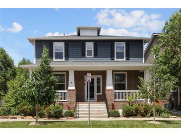 Charming two-story home with a welcoming front porch and well-maintained landscaping at 10109 E 28Th Ave, Denver, CO 80238