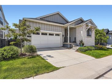 Charming home with a two-car garage and landscaped front yard at 11253 Moondance Trl, Littleton, CO 80125