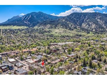 Stunning aerial view of the property nestled in a lush, green neighborhood with a mountain backdrop at 753 Pearl St, Boulder, CO 80302