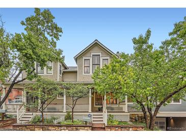 Charming two-story home with a welcoming front porch and mature trees at 753 Pearl St, Boulder, CO 80302