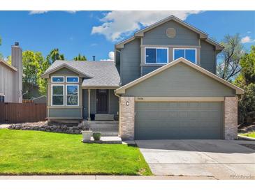 Charming two-story home with a well-maintained lawn and attached two-car garage at 9494 Devonshire Pl, Highlands Ranch, CO 80126