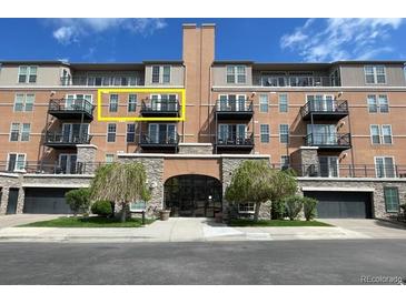 Spacious condo building featuring black balconies, lovely trees, and a convenient drive-in garage at 640 11Th St # 302, Golden, CO 80401