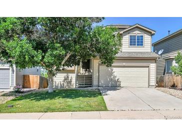 Charming two-story home with a well-maintained front yard and a two-car garage at 5483 Ben Park Cir, Parker, CO 80134