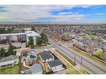 Sweeping aerial view showcasing the neighborhood and distant mountain views at 1990 Ulster St, Denver, CO 80220