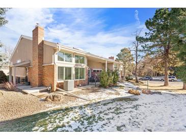 Back exterior view with landscaping and patio at 6967 E Girard Ave, Denver, CO 80224