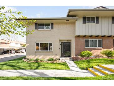 Charming two-story home featuring a well-maintained lawn and brick accents at 12648 W Virginia Ave, Lakewood, CO 80228
