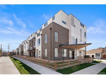 Modern townhome showcasing a sleek architectural style, complemented by well-manicured lawn and inviting walkway at 3520 W Conejos Pl # 11, Denver, CO 80204