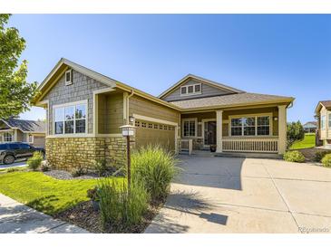 Charming ranch-style home with stone accents, an attached garage, and a well-maintained front lawn at 23738 E Clifton Pl, Aurora, CO 80016