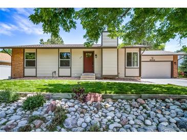 Charming single-story home with a manicured lawn and attractive stone landscaping at 4064 S Olathe Ct, Aurora, CO 80013