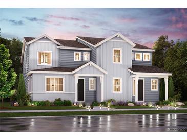 Charming two-story home with light-blue siding, well-manicured landscaping, and eye-catching curb appeal at 14107 Deertrack Ln, Parker, CO 80134