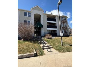 Multi-story apartment building with dark balconies and stone accents, showcasing a well-maintained exterior at 12304 W Cross Dr # 304, Littleton, CO 80127