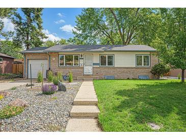 Charming single-story home with a well-manicured lawn and inviting curb appeal at 6147 Jellison Way, Arvada, CO 80004