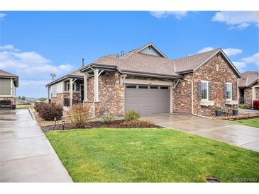 Charming single-Gathering home featuring a stone exterior, attached garage, and beautifully landscaped lawn at 24943 E Phillips Pl, Aurora, CO 80016